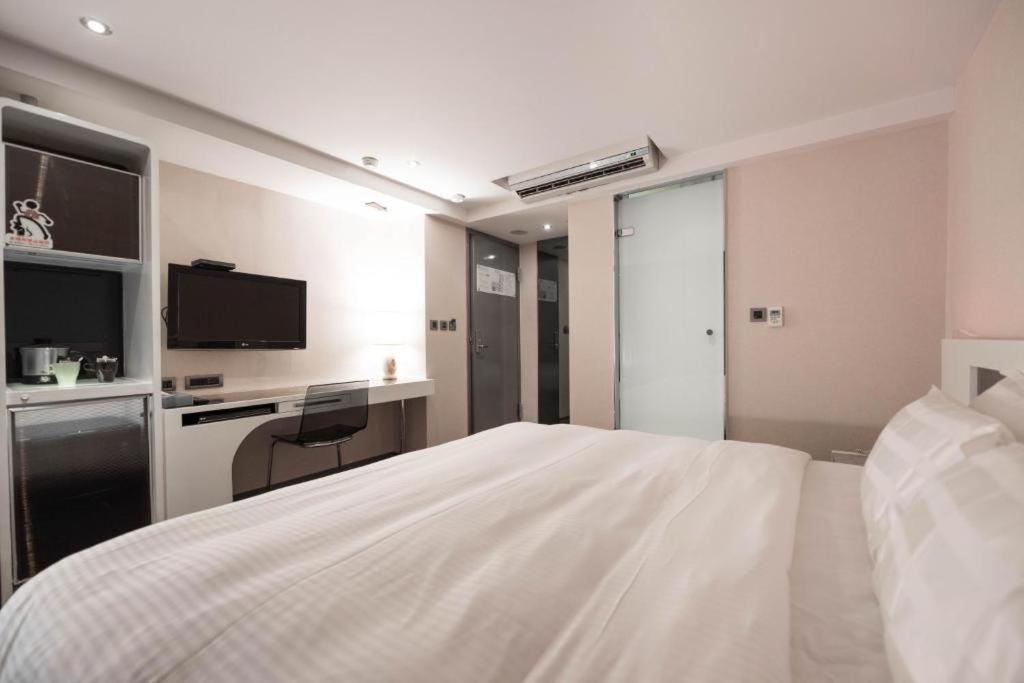 Postel nebo postele na pokoji v ubytování Saual Keh Hotel