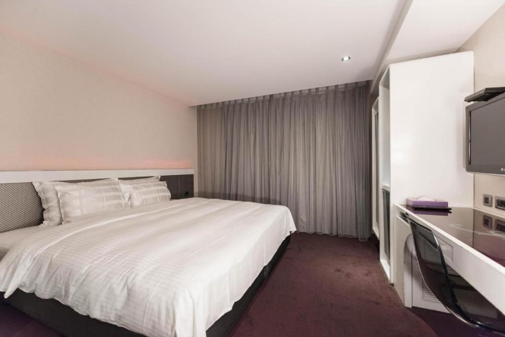 Postel nebo postele na pokoji v ubytování Saual Keh Hotel