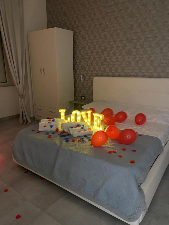 a birthday cake with lit candles on a bed at Brighter's Room in Naples