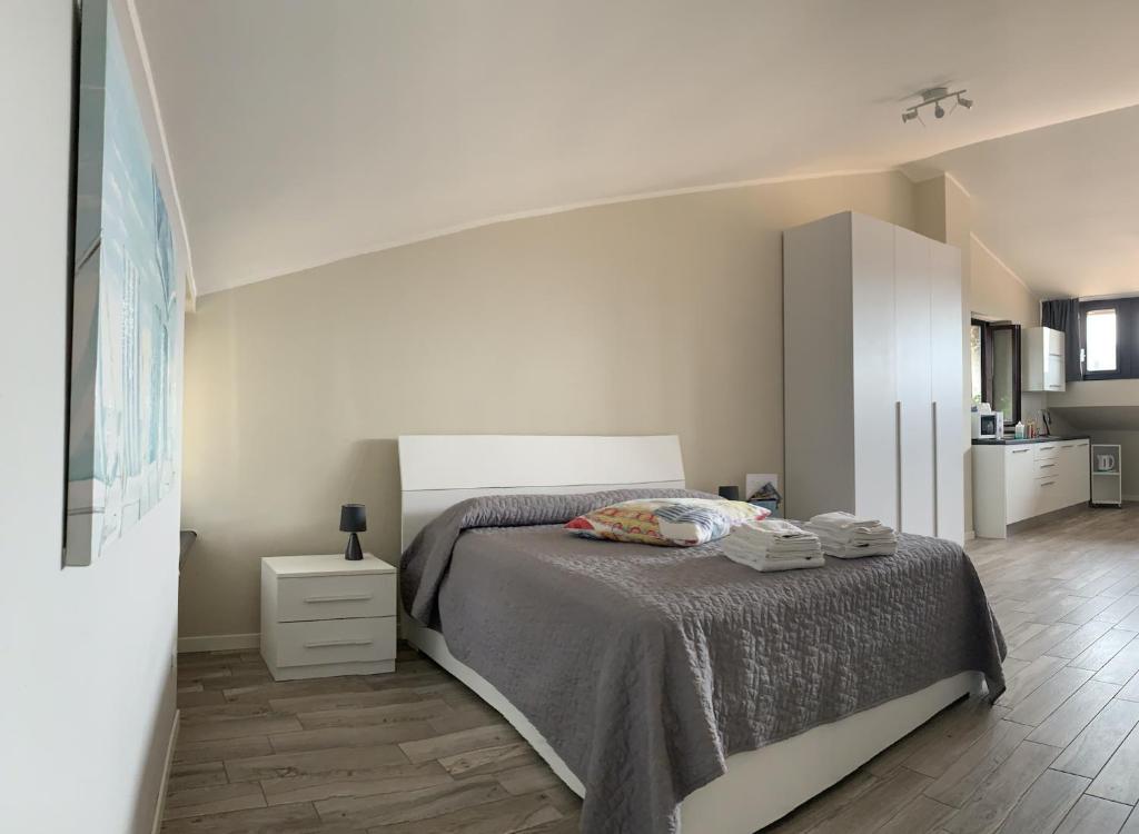 a white bedroom with a bed and a white cabinet at Al Lago da Lilly in Gargnano