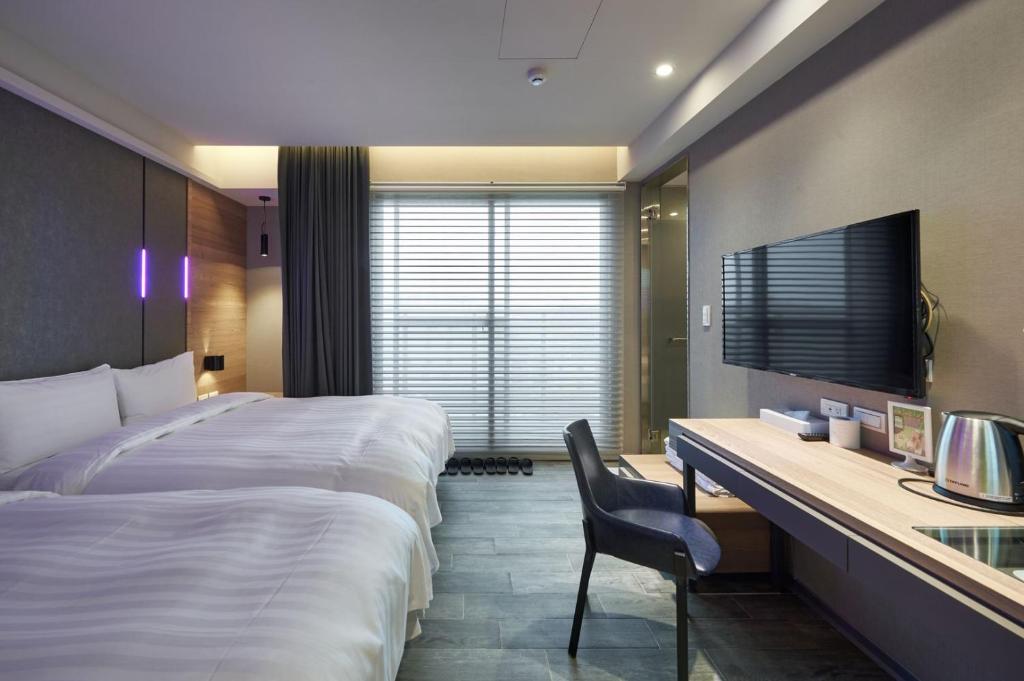 Rúm í herbergi á KIWI SHARE HOTEL ZHONGLI