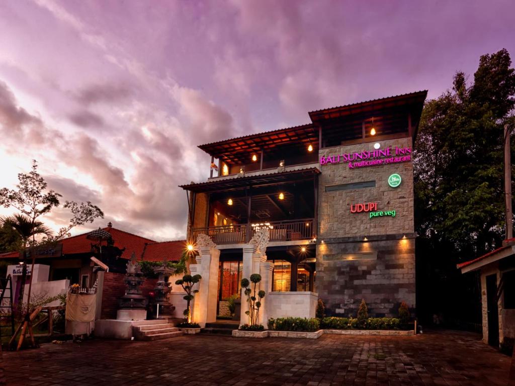 a building with a sign on the side of it at Bali Sunshine Nusa Dua in Nusa Dua