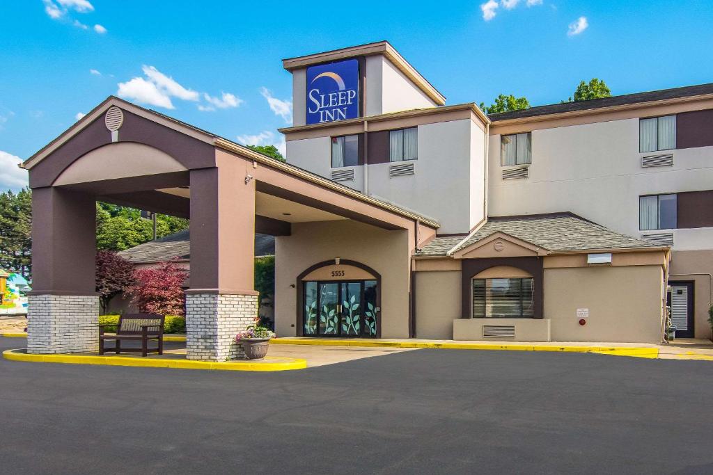 a front view of a hotel with a parking lot at Sleep Inn in Austintown