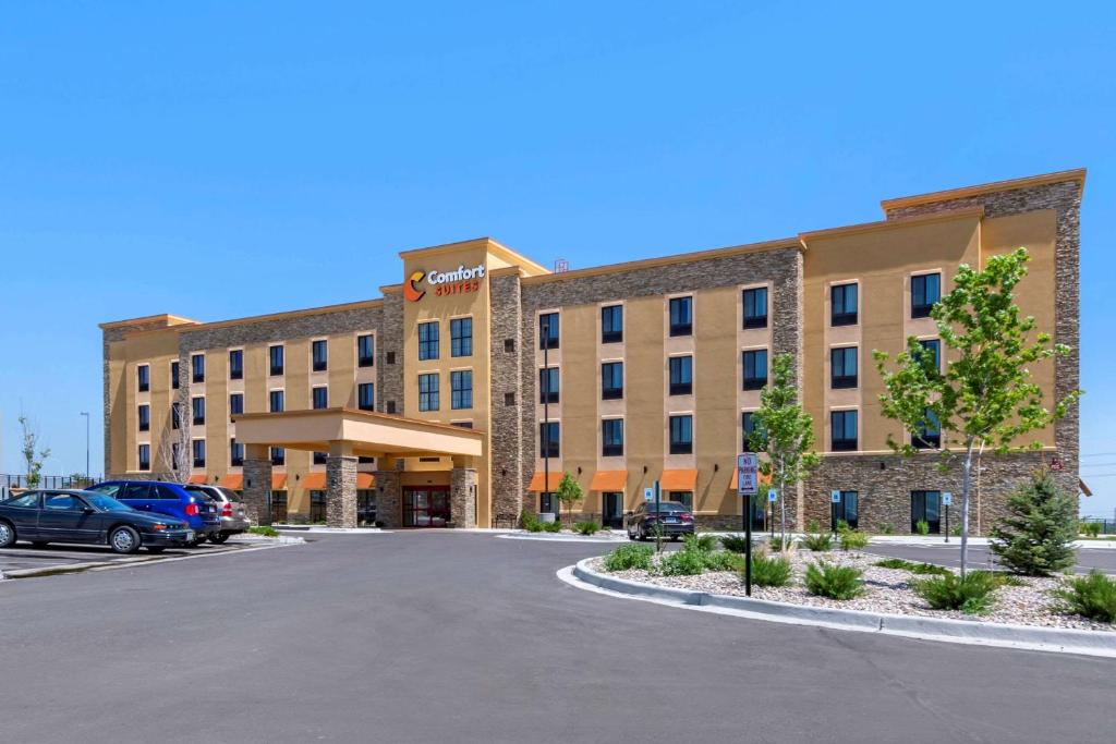 a large building with a parking lot in front of it at Comfort Suites Broomfield-Boulder-Interlocken in Broomfield