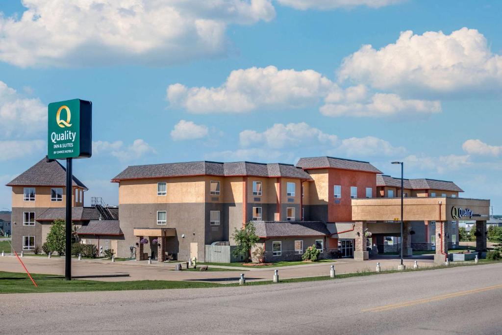a building on the side of a road with a sign at Quality Inn & Suites in Rimbey