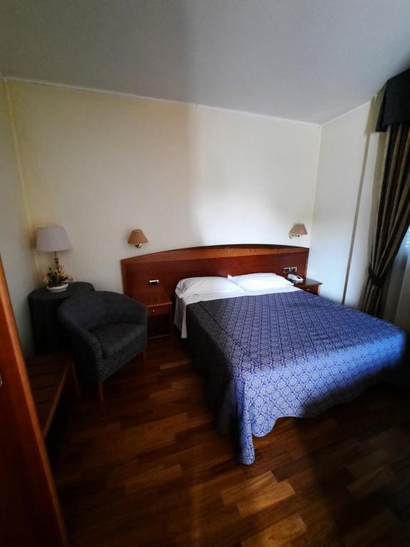 Postel nebo postele na pokoji v ubytování Hotel Rossi