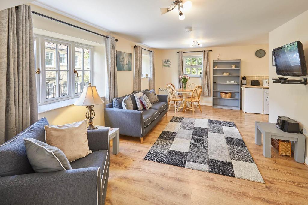 a living room with two couches and a table at Host & Stay - Kingfisher Cottage in Levisham