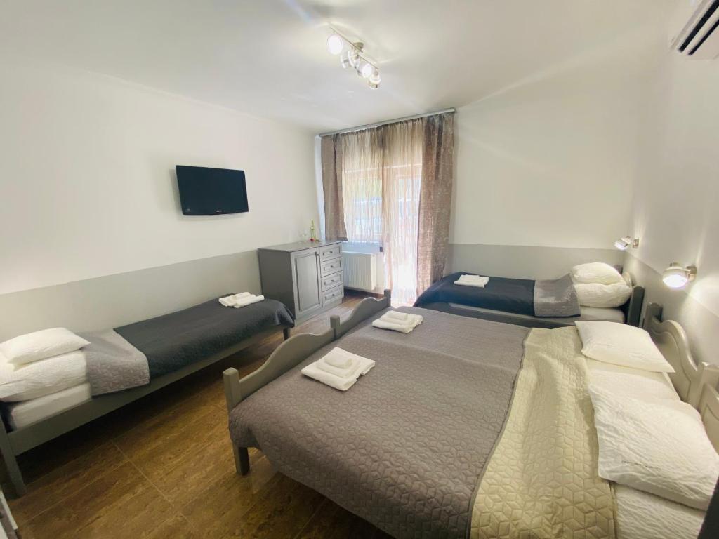 Postel nebo postele na pokoji v ubytování Linton Apartmanház