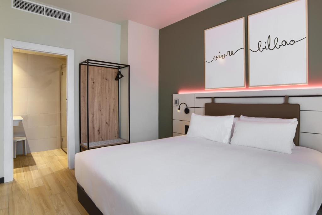 A bed or beds in a room at voco Bilbao - City by IHG