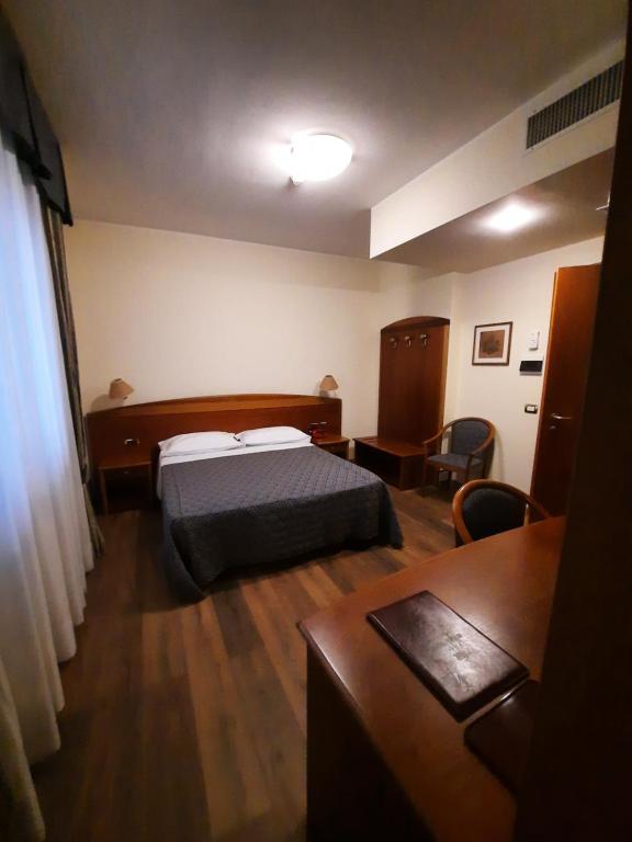Postel nebo postele na pokoji v ubytování Hotel Rossi