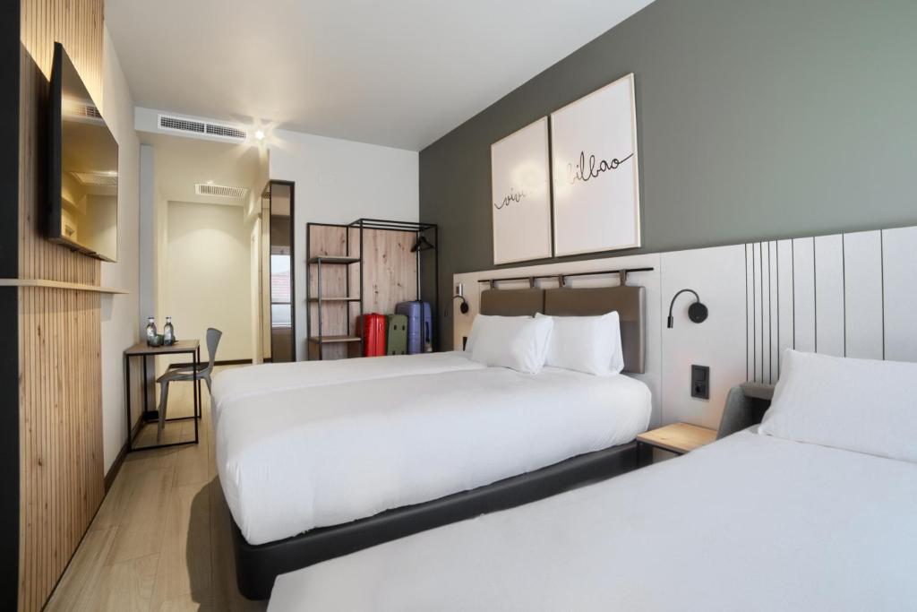 A bed or beds in a room at voco Bilbao - City by IHG