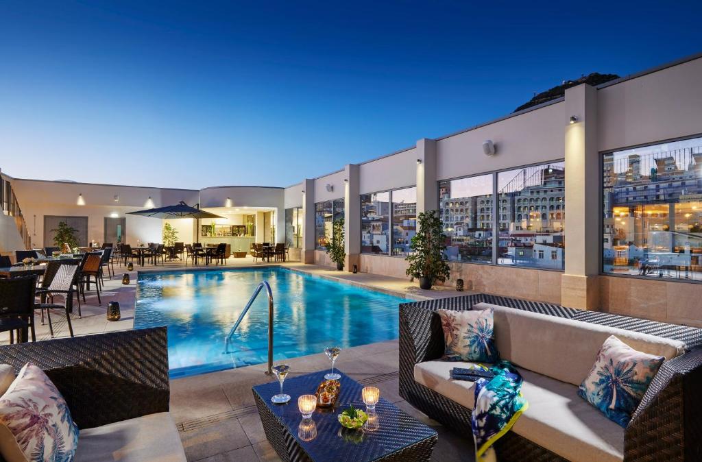 a swimming pool on the roof of a building at The Eliott Hotel in Gibraltar