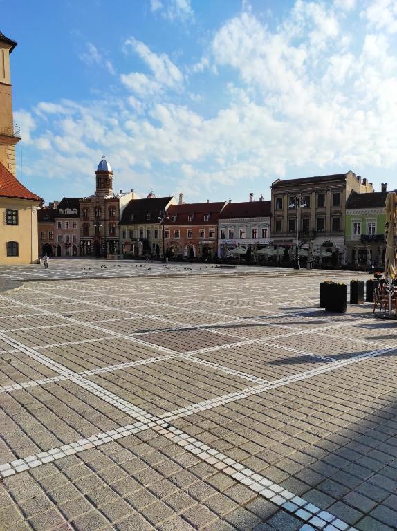 an empty parking lot with buildings in the background at Robi Studio in Braşov