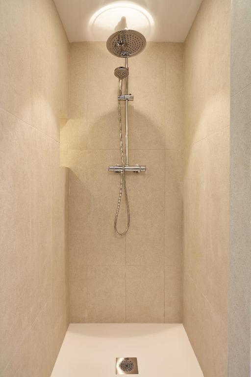 a shower with a shower head in a bathroom at Can Salia in San Antonio Bay