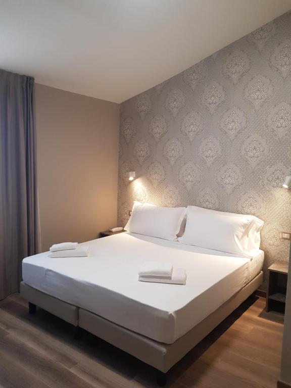 Postel nebo postele na pokoji v ubytování Hotel Della Rosa