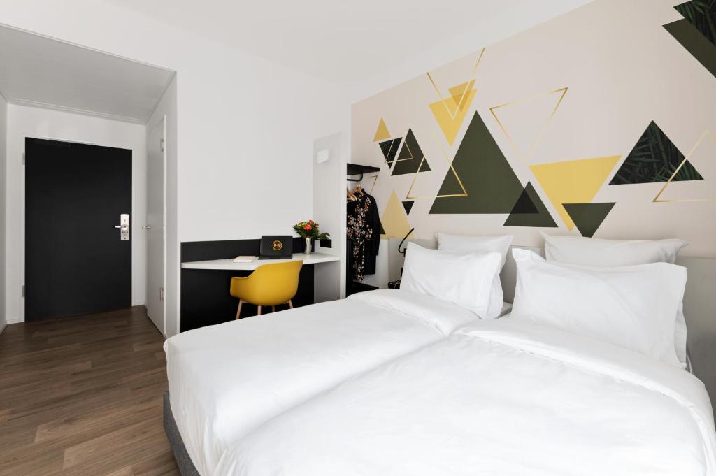 Postel nebo postele na pokoji v ubytování B&B HOTEL Oftringen