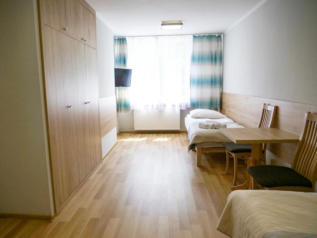 Posteľ alebo postele v izbe v ubytovaní CKS Kraków (Centrum Konferencyjno-Szkoleniowe CS Natura Tour)