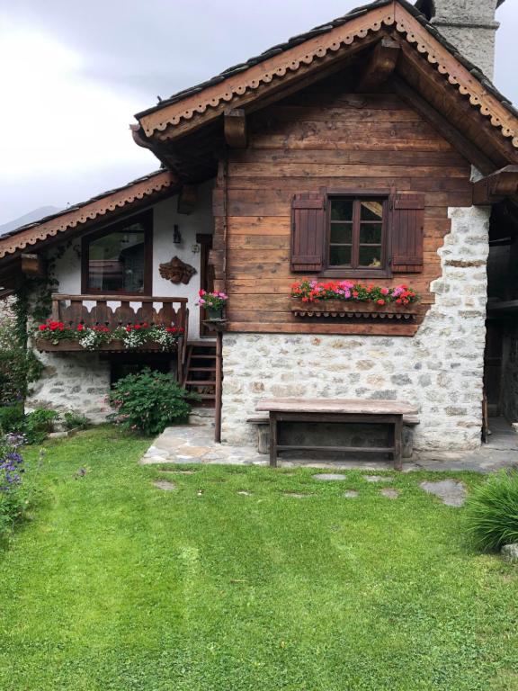 a house with flower boxes on the front of it at Baita Meyen - Val Ferret in Courmayeur