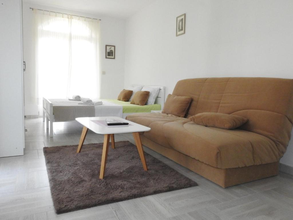 a living room with a couch and a table at Luna Apartments in Budva