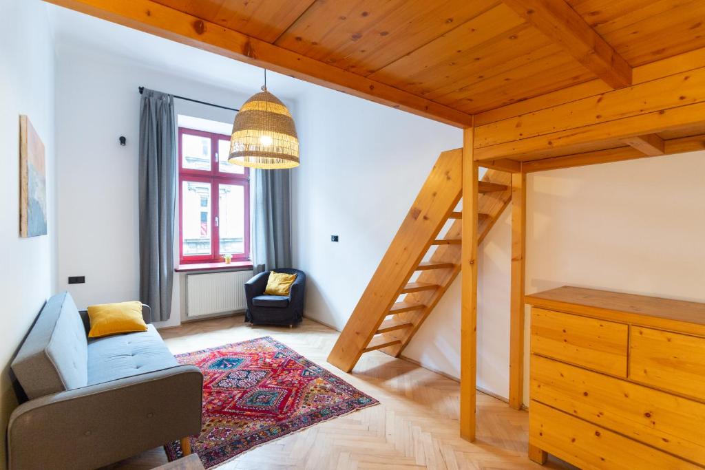 a living room with a loft bed and a staircase at Artistic&Cozy in the Old Town in Krakow