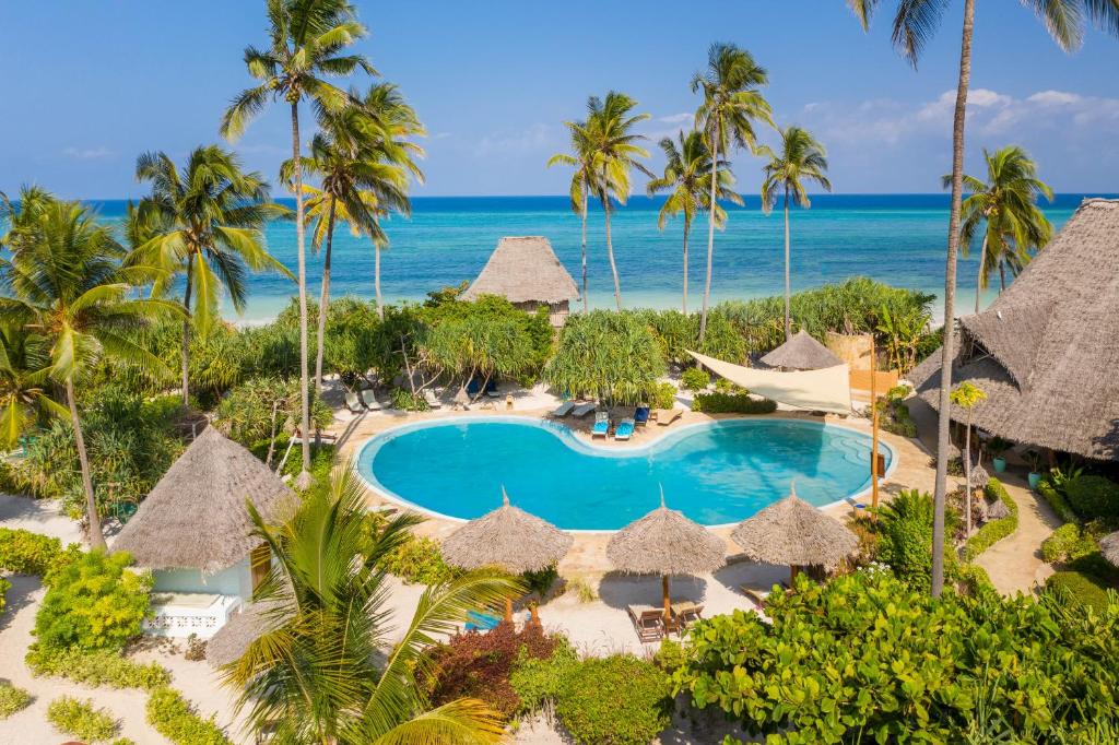 an aerial view of a resort with a swimming pool and the ocean at Zanzibar Queen Hotel in Matemwe