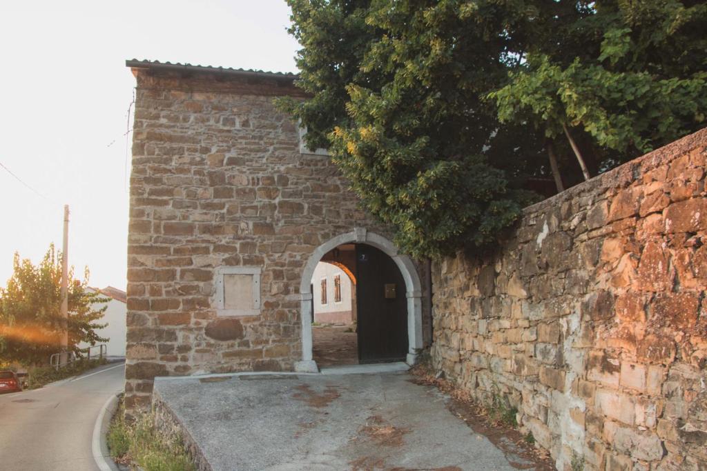 un ingresso a un muro di mattoni con porta di Oltre l'arco a San Dorligo della Valle