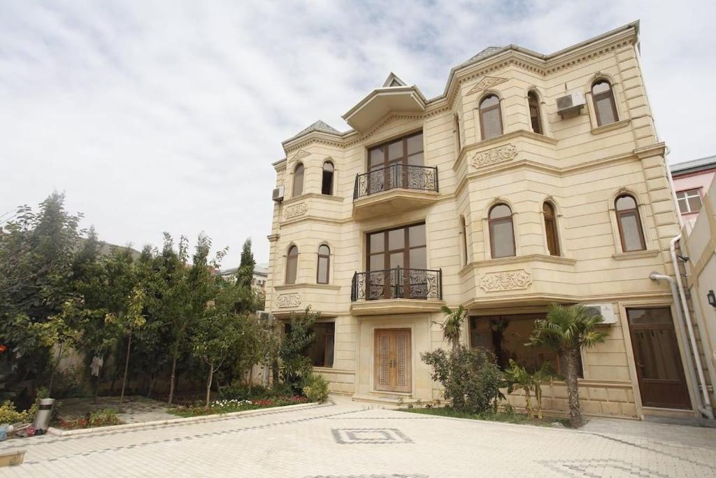 a large white building on a street at Baku Entire Villa in Baku