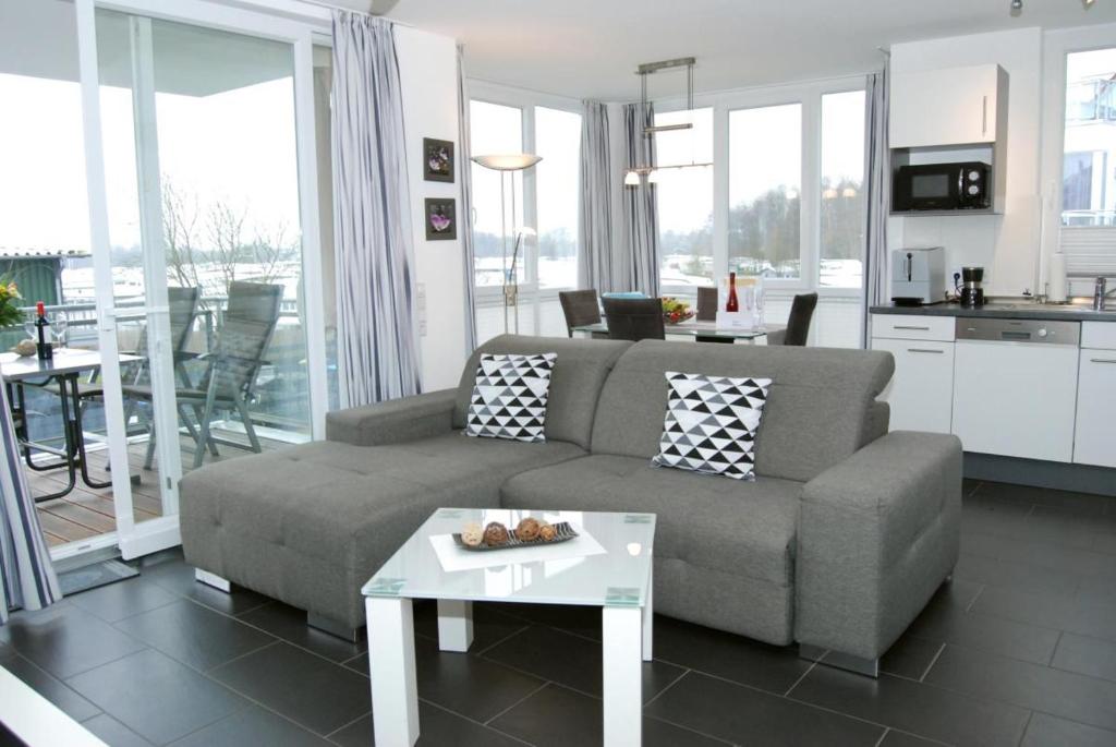a living room with a couch and a table at Meeresrauschen 6 in Großenbrode