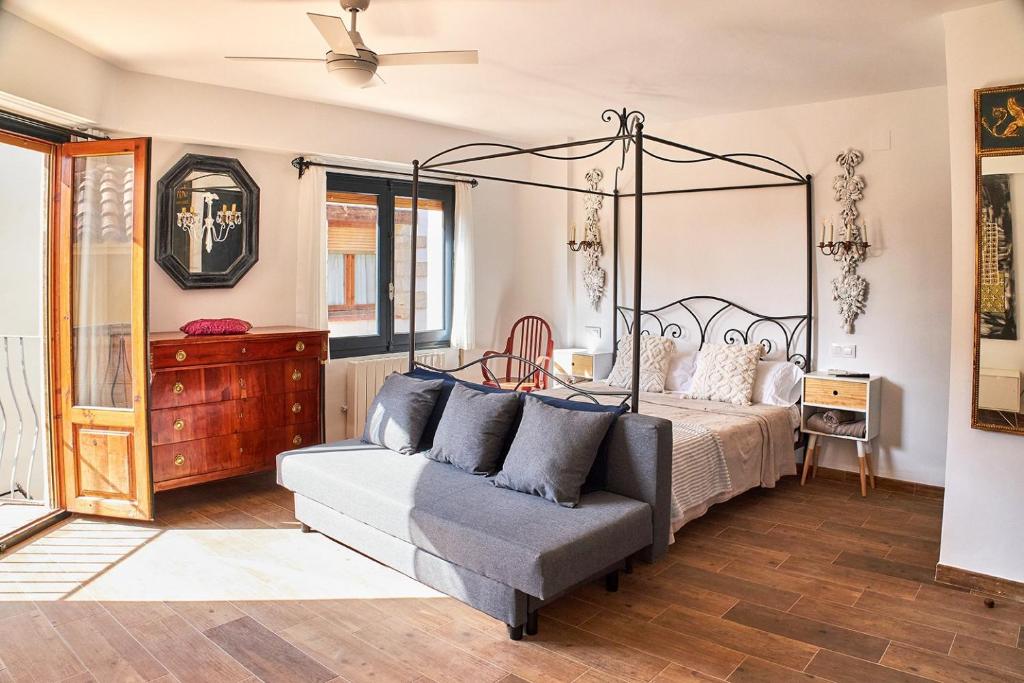 a bedroom with a bed and a couch at Vista al Castillo de Mora de Rubielos VUTE-22-036 in Mora de Rubielos