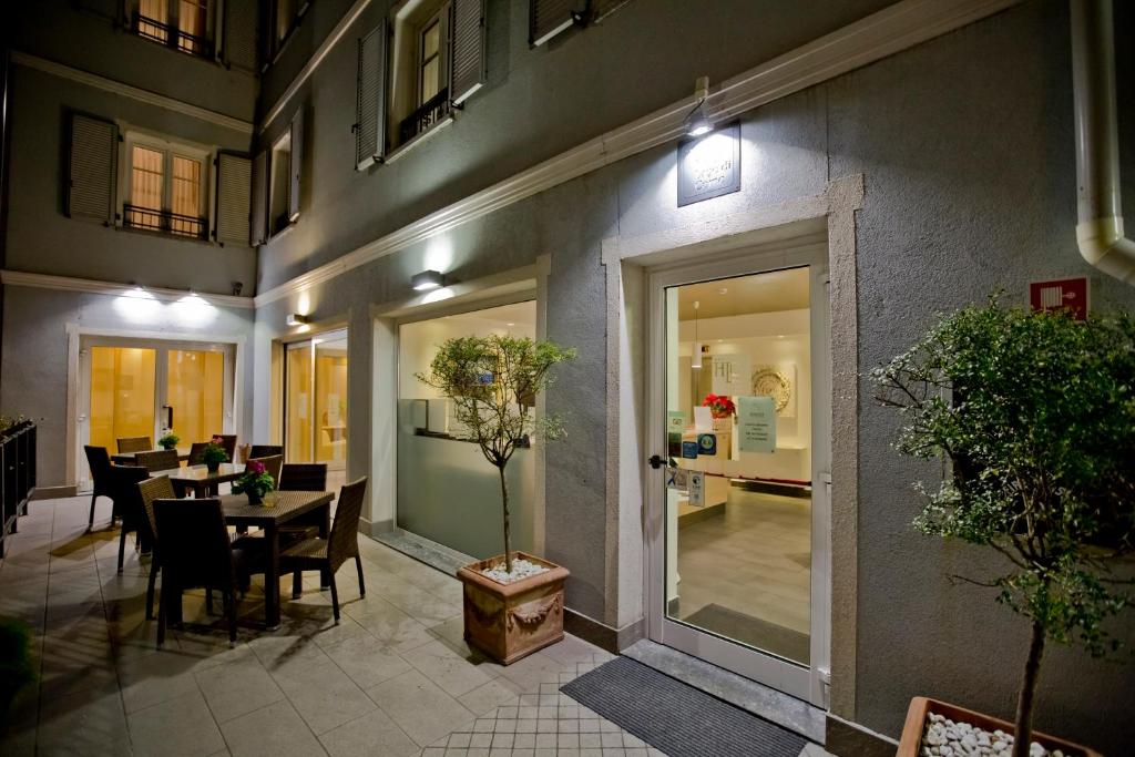 コーリコにあるHotel Lago di Comoのテーブルと椅子のあるレストラン、ダイニングルームを併設しています。