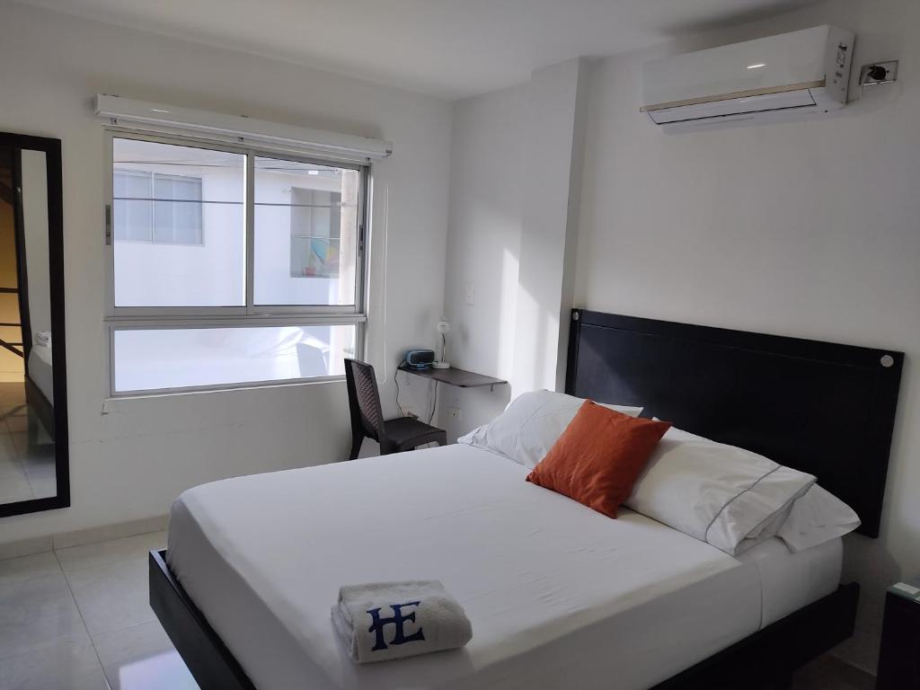 Postel nebo postele na pokoji v ubytování HOTEL ESCALA GC Valledupar