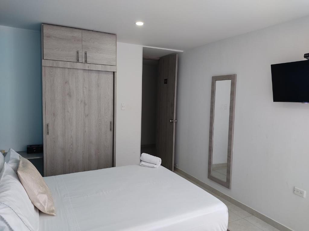 Postel nebo postele na pokoji v ubytování HOTEL ESCALA GC Valledupar