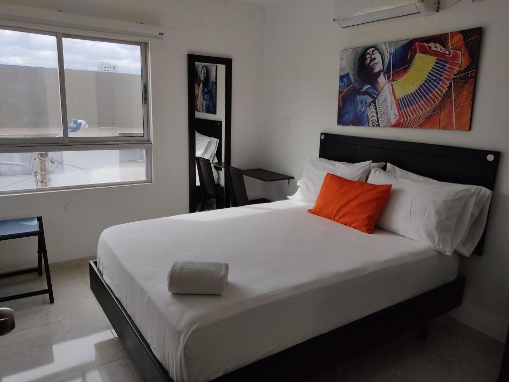 Postel nebo postele na pokoji v ubytování HOTEL ESCALA GC Valledupar