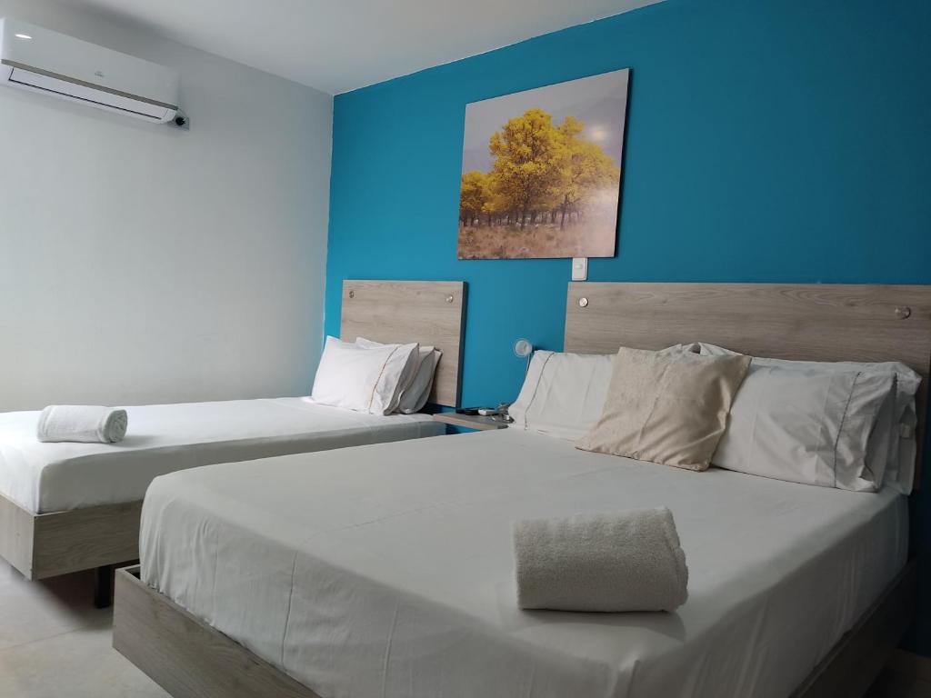 Postel nebo postele na pokoji v ubytování HOTEL ESCALA GC Valledupar