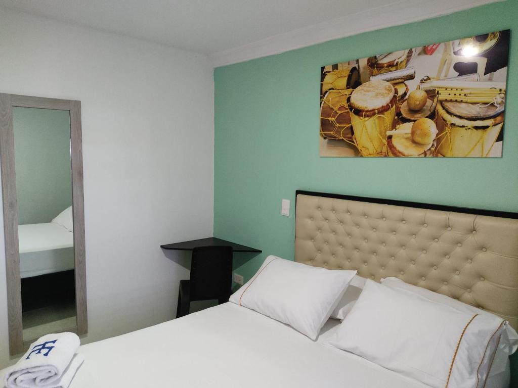 Postel nebo postele na pokoji v ubytování HOTEL ESCALA GC Valledupar
