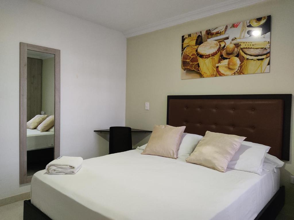 Postel nebo postele na pokoji v ubytování HOTEL ESCALA GC Valledupar