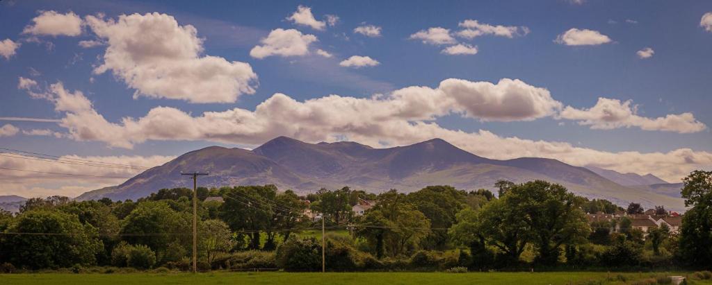 a view of a mountain range with trees and clouds at Rookery Mews Apartments - Killarney Self Catering in Killarney