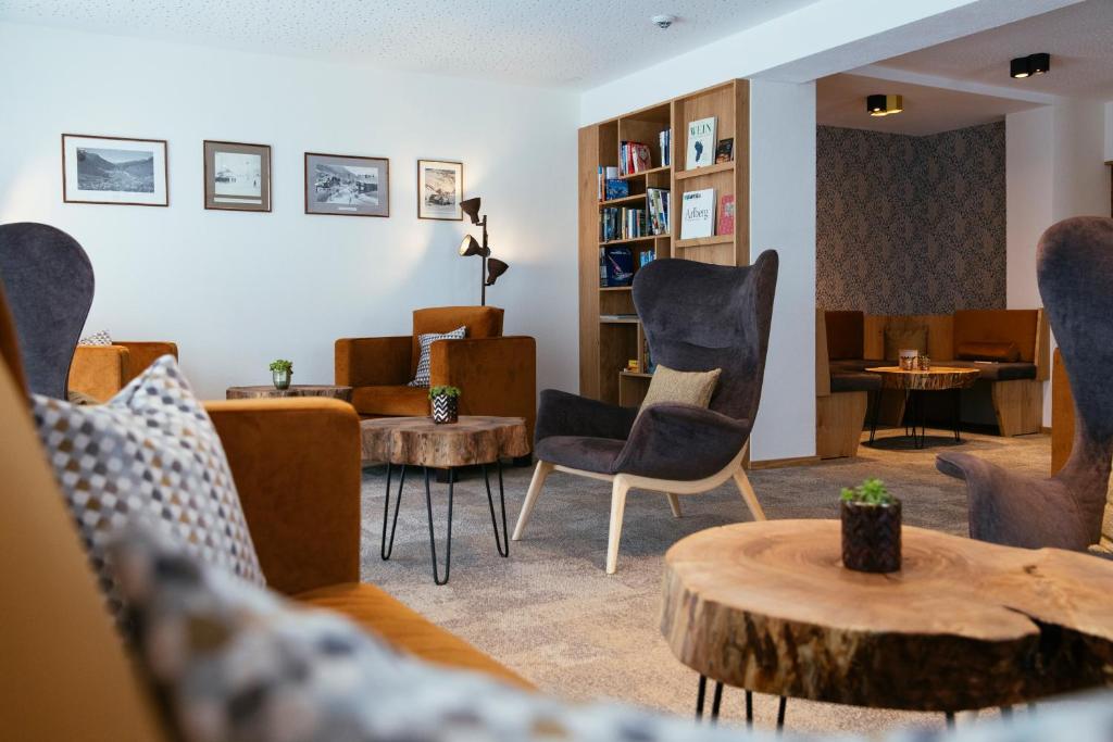 a living room with chairs and a table at Hotel Montfort in Sankt Anton am Arlberg