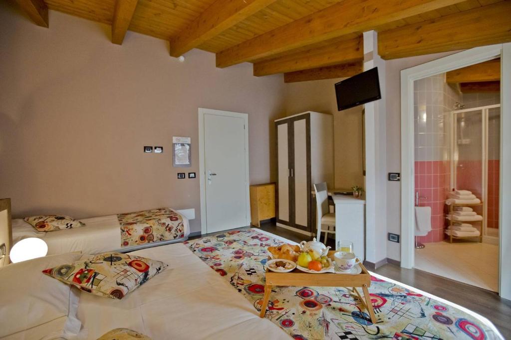 Postel nebo postele na pokoji v ubytování Hotel Lago di Como