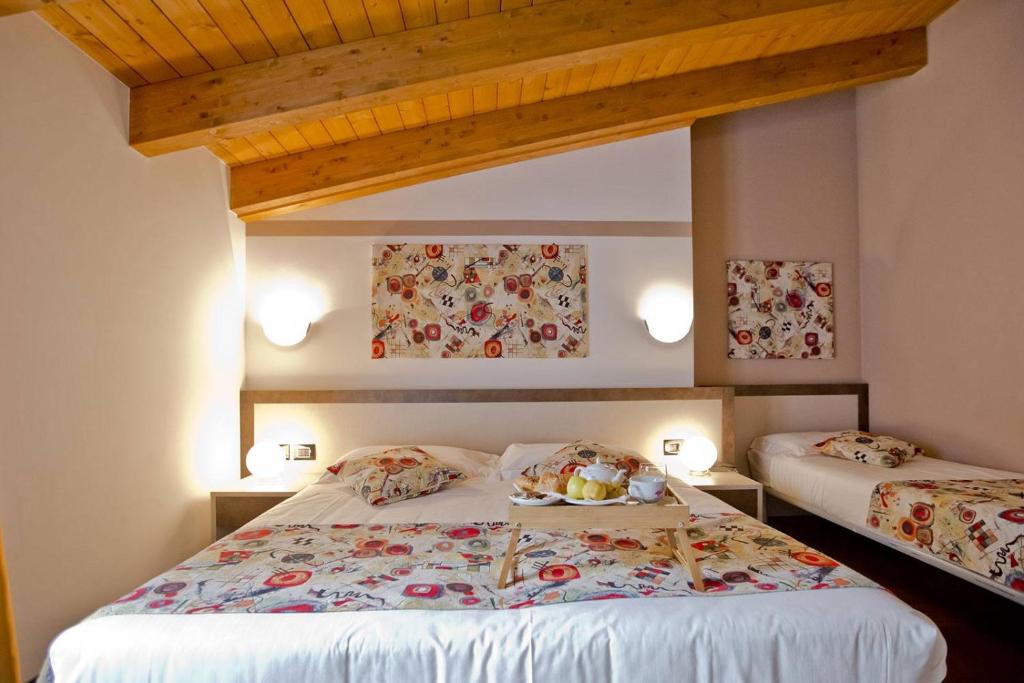 Postel nebo postele na pokoji v ubytování Hotel Lago di Como