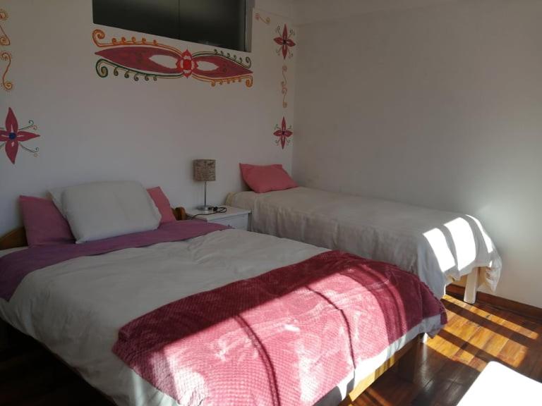 Postel nebo postele na pokoji v ubytování Hostal Chaska Wasi