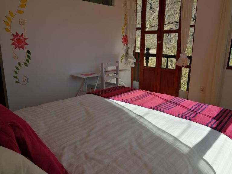 Postel nebo postele na pokoji v ubytování Hostal Chaska Wasi