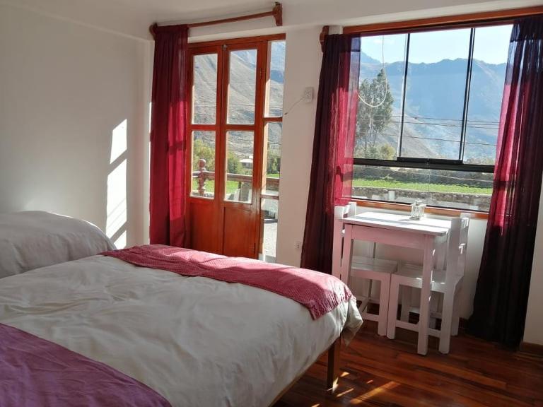 Postel nebo postele na pokoji v ubytování Hostal Chaska Wasi