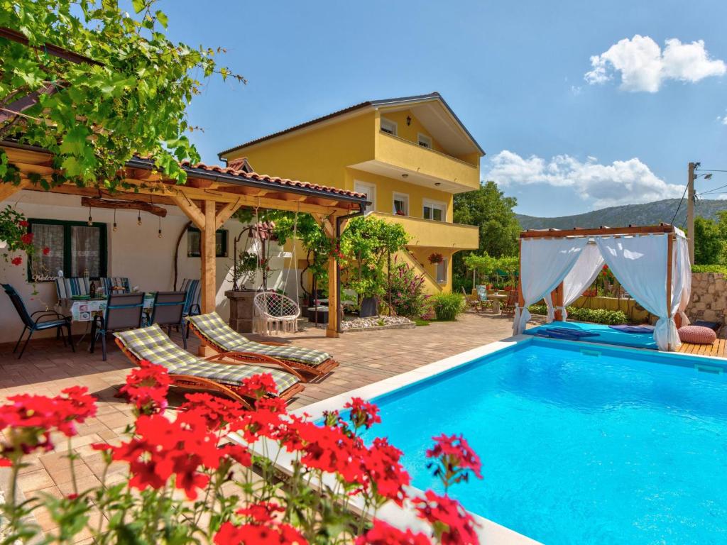 a villa with a swimming pool and a house at Holiday Home Villa Anđelika by Interhome in Drivenik