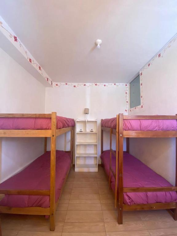 Postel nebo postele na pokoji v ubytování Hostal Chaska Wasi