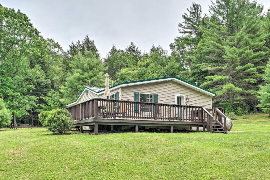 a house with a large deck in a yard at Deck, Fire Pit & Yard: Mountain Escape! in Benezette