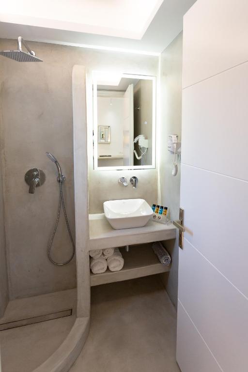 a bathroom with a sink and a shower at Likio Studios in Batsi