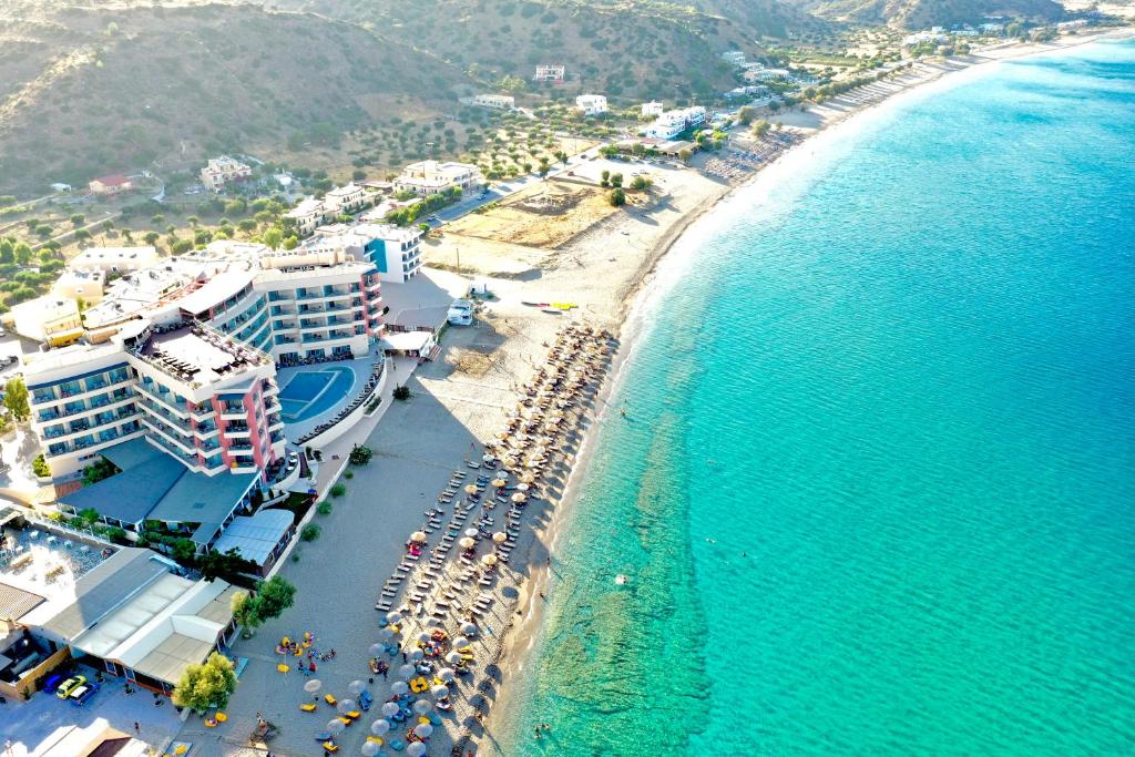 an aerial view of a beach with hotels and the ocean at Konstantinos Palace in Karpathos