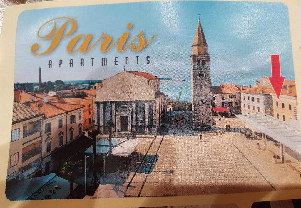 een boek met een foto van een stad met een klokkentoren bij Apartments Paris in Umag