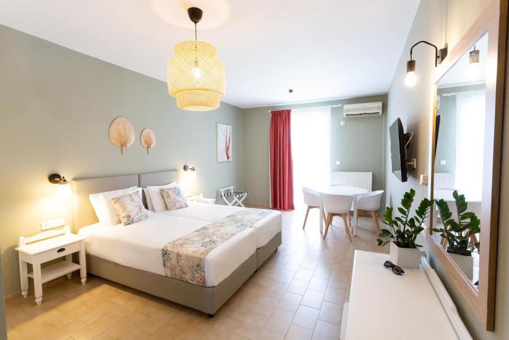 a bedroom with a large bed and a table at Likio Studios in Batsi